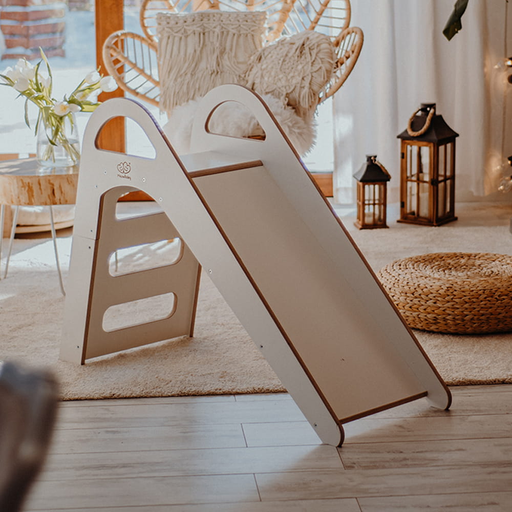 White and natural wood slide in bright nursery with minimalist Scandi design
