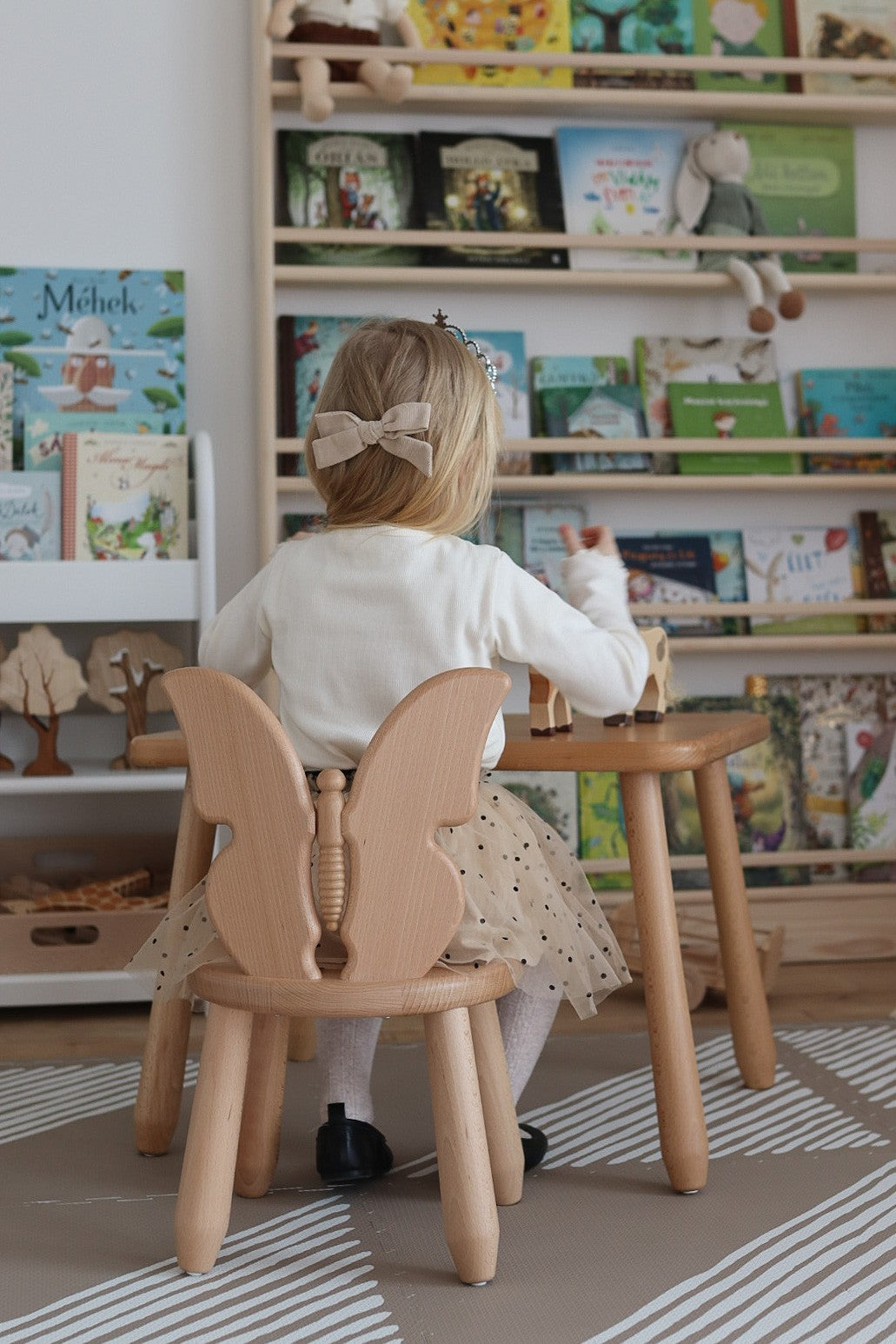 Child sitting at Kidozia Butterfly beech wood table and chair set