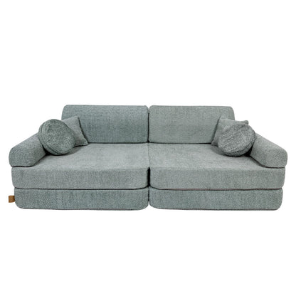 Fresh mint boucle modular sofa in lounge position with bolster pillows