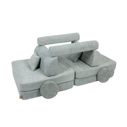 Playroom sofa rearranged as fort with cushions stacked for creative play
