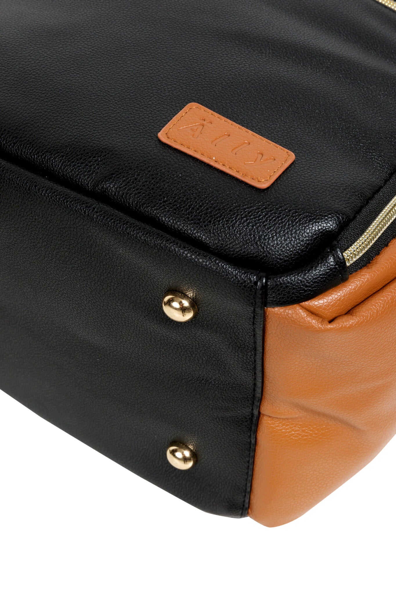 Bottom corner detail showing tan leather patch and gold accent studs