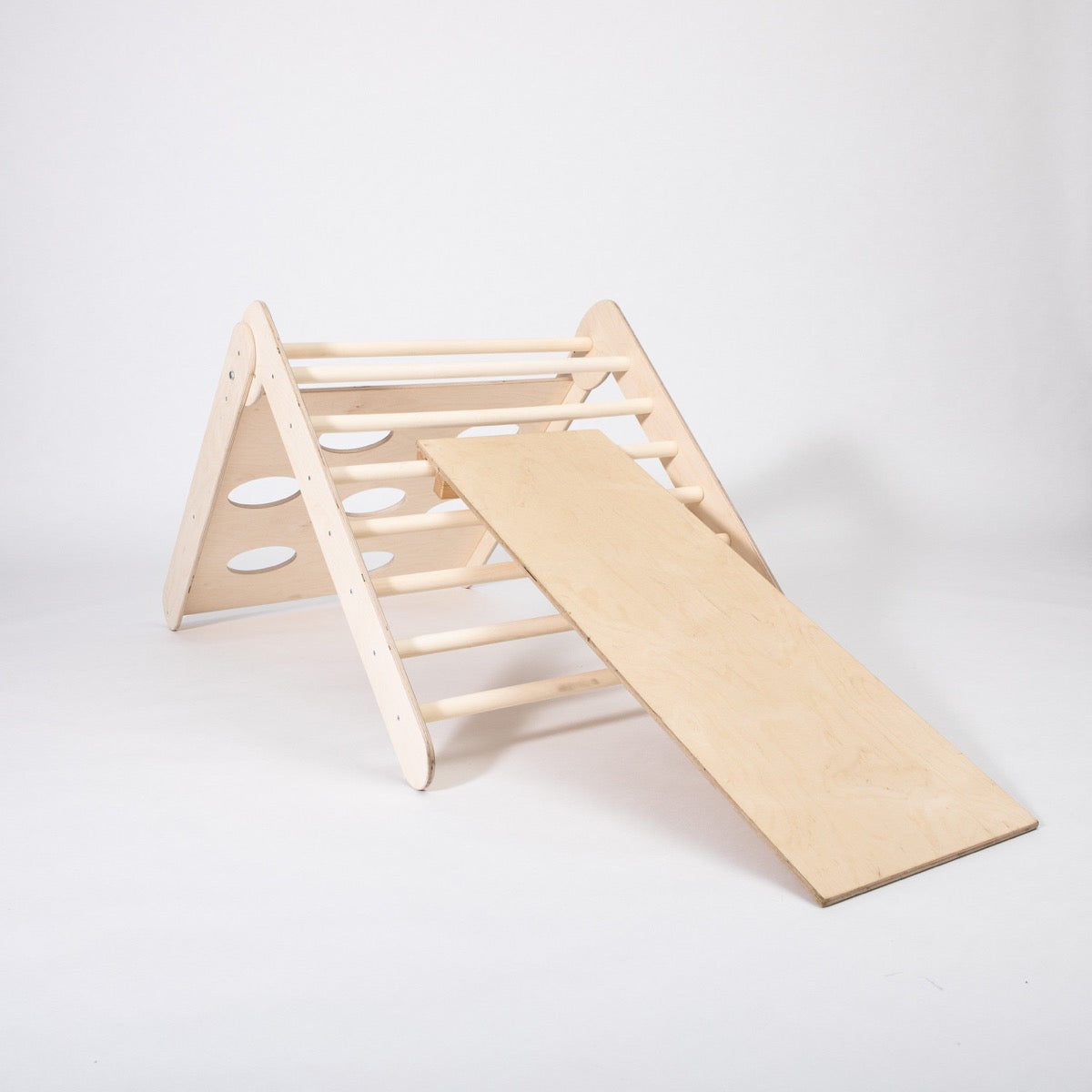Wooden climbing triangle with attached ramp on white background, studio view