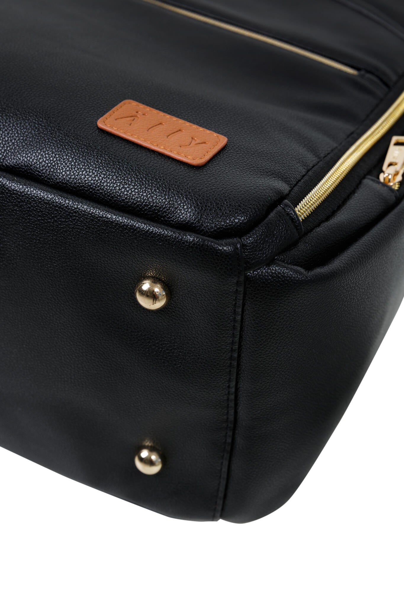 Close-up of copper logo patch and gold stud details on espresso diaper bag