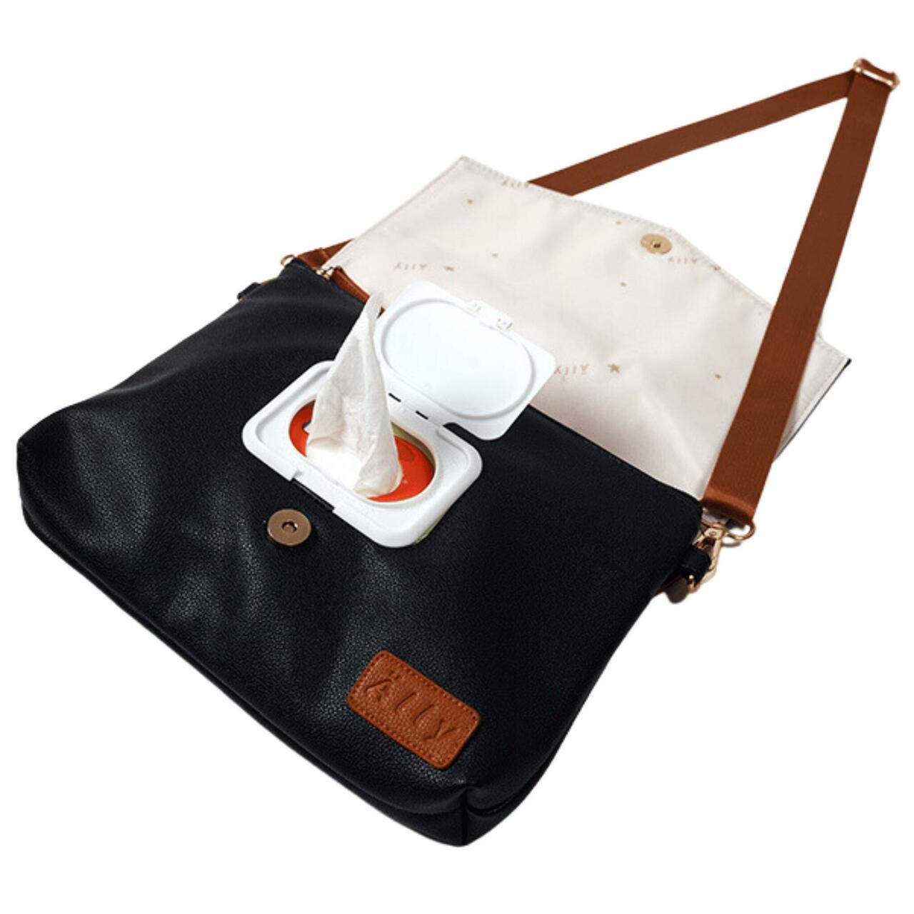 Black coffee baby handbag displayed flat with cream changing pad insert and accessories
