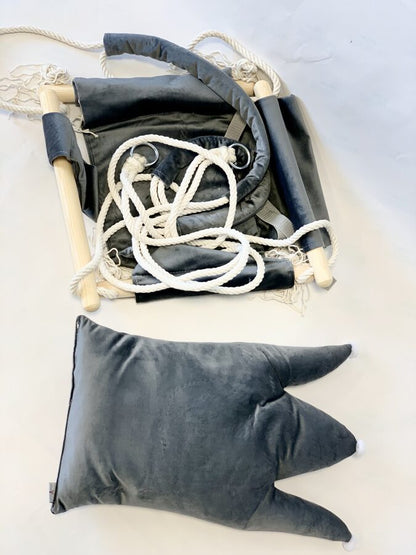 Grey crown shaped velvet cushion swing displayed flat with rope and wooden hardware