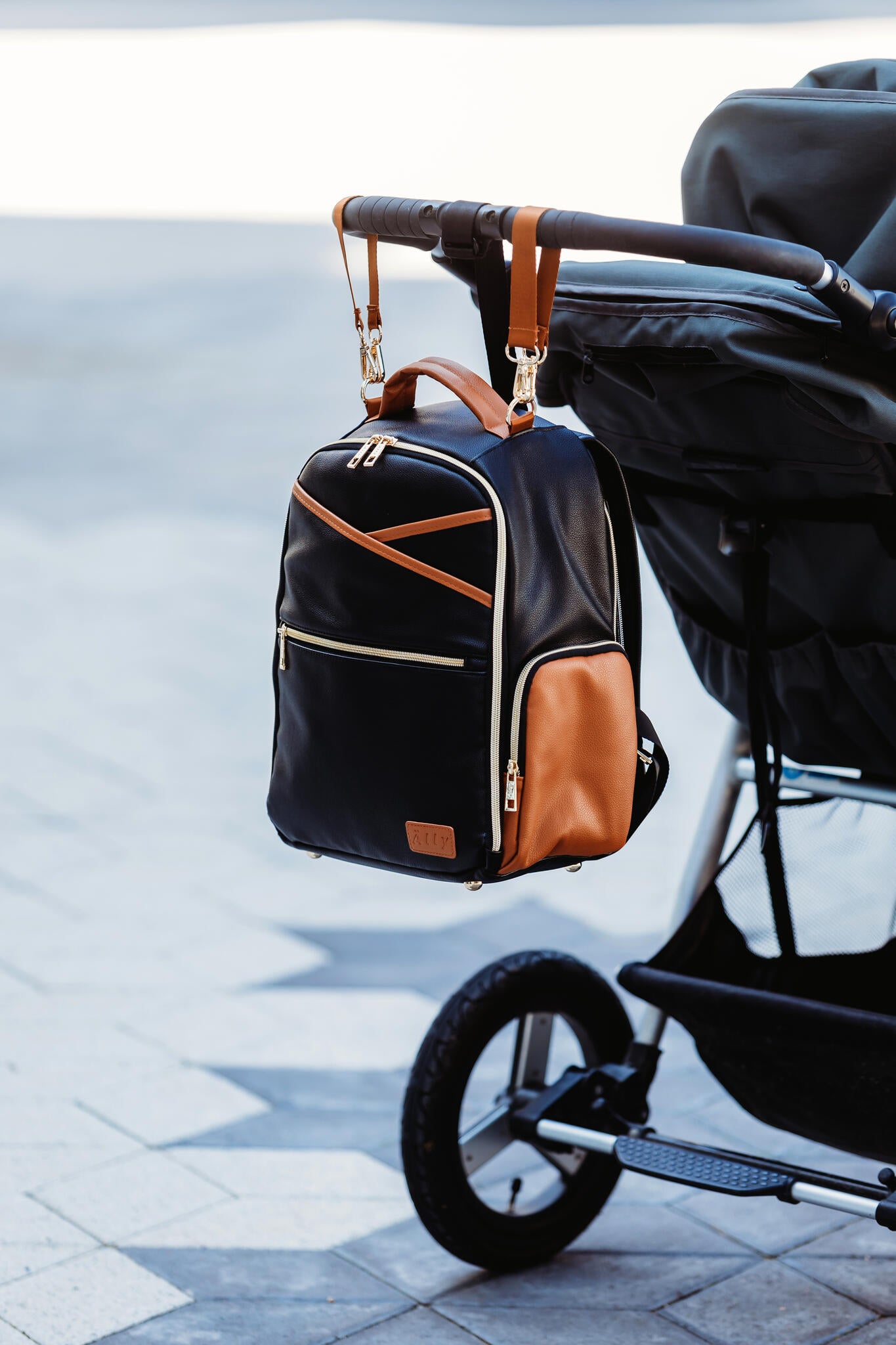 Tan and white changing pad inside packed diaper bag