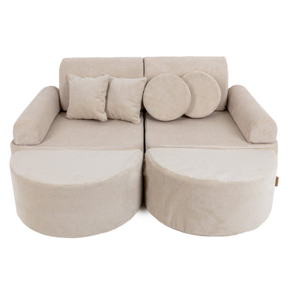 Medium modular kids sofa in ecru slimcord with two curved seats, cylindrical bases, and round accent pillows
