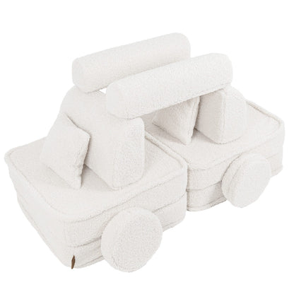 Bearly cream modular sofa rearranged into toy train shape with cushions and wheels