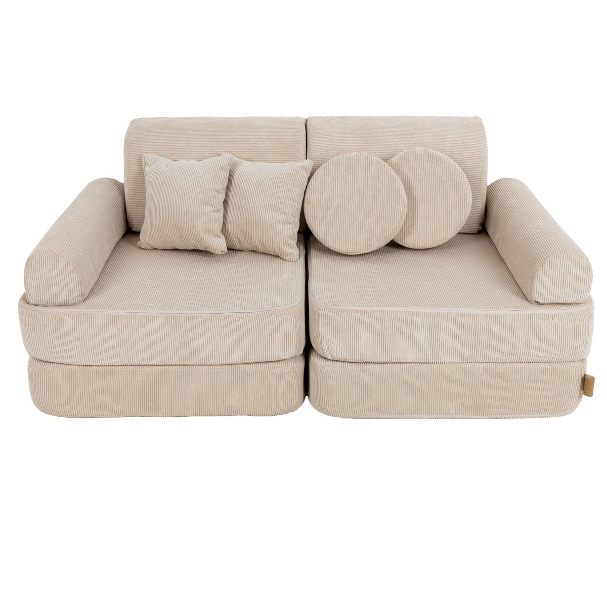 Modular kids sofa with square cushions and round pillows arranged on backrest in ecru