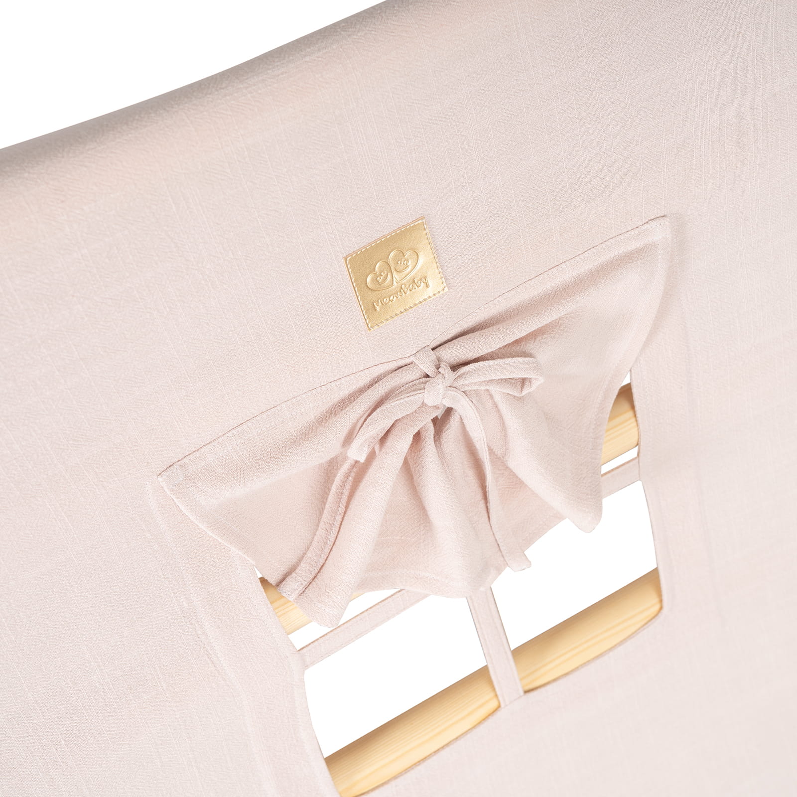 Pink fabric cover detail with gold brand label and window tie closure