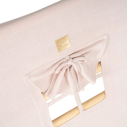 Pink fabric cover detail with gold brand label and window tie closure
