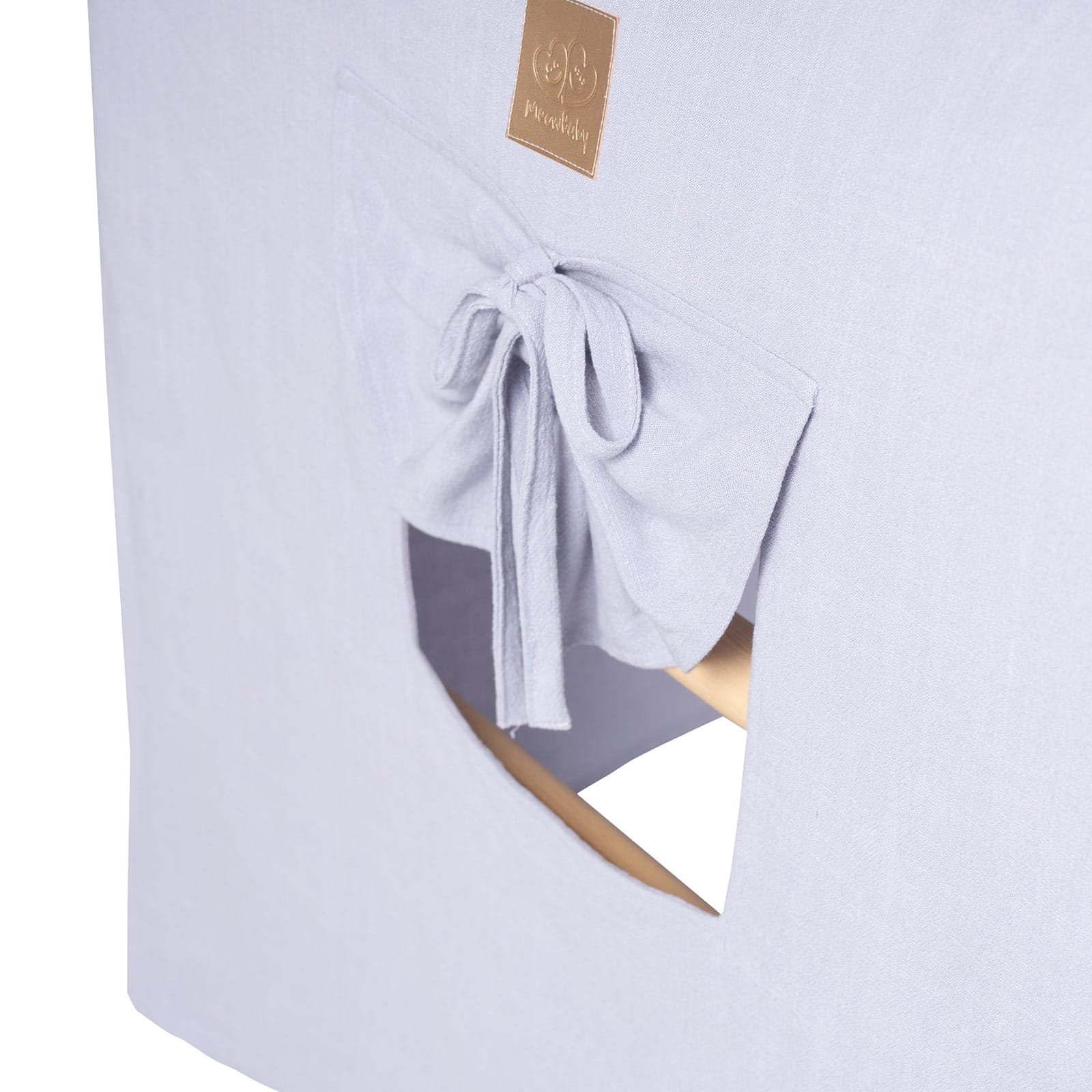 Blue-grey fabric cover detail with window opening and tied fabric closure on ladder house