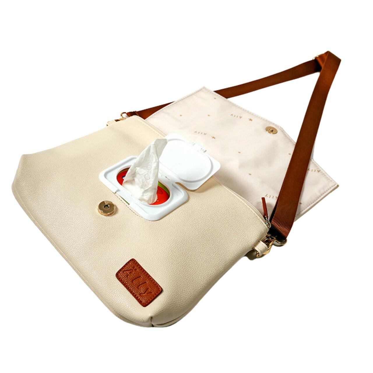 Mother and baby portrait with cappuccino lightweight handbag on shoulder
