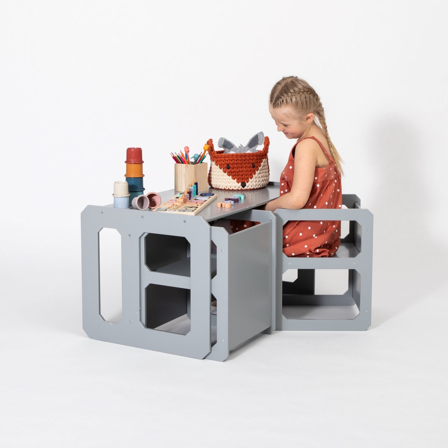 Toddler engaging with craft materials at gray Montessori weaning table and chair set
