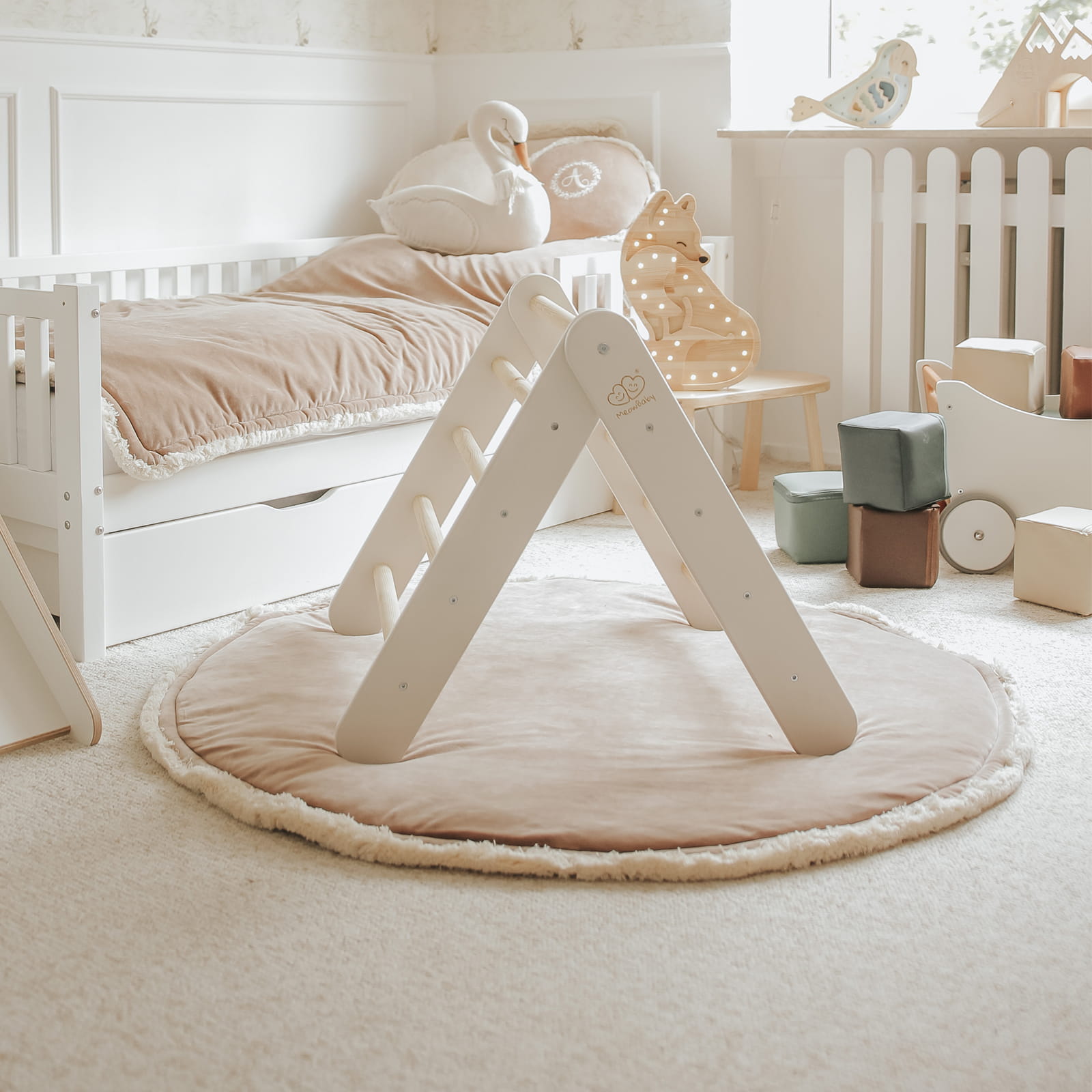 White climbing wall and natural wood slide in soft gender-neutral bedroom