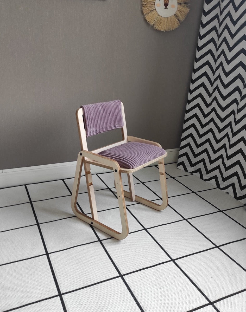 Cannon pink Montessori chair with white frame positioned against gray wall