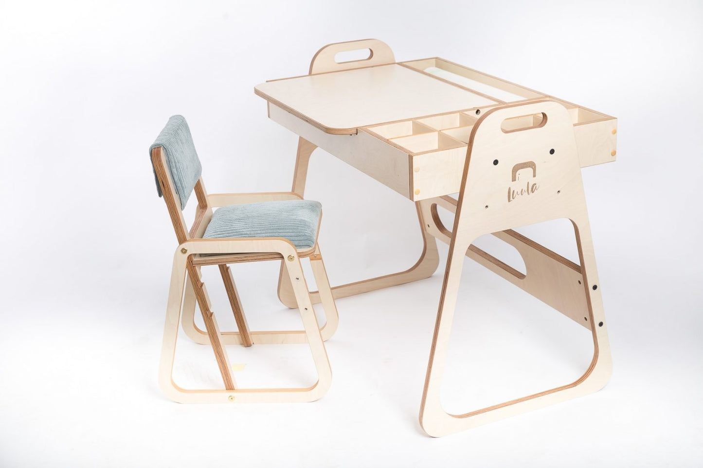 Child working at Montessori table with supplies organized and chalkboard active