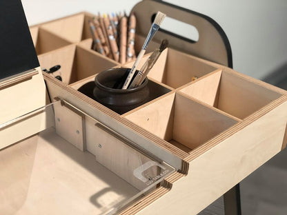 Close-up of organized pencil holder and supply storage in Montessori table drawer