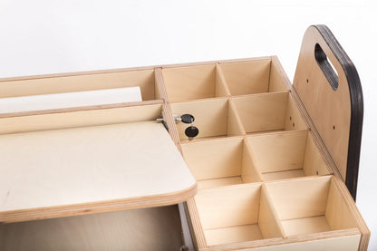 Side view of Montessori table showing transparent acrylic board and compartments