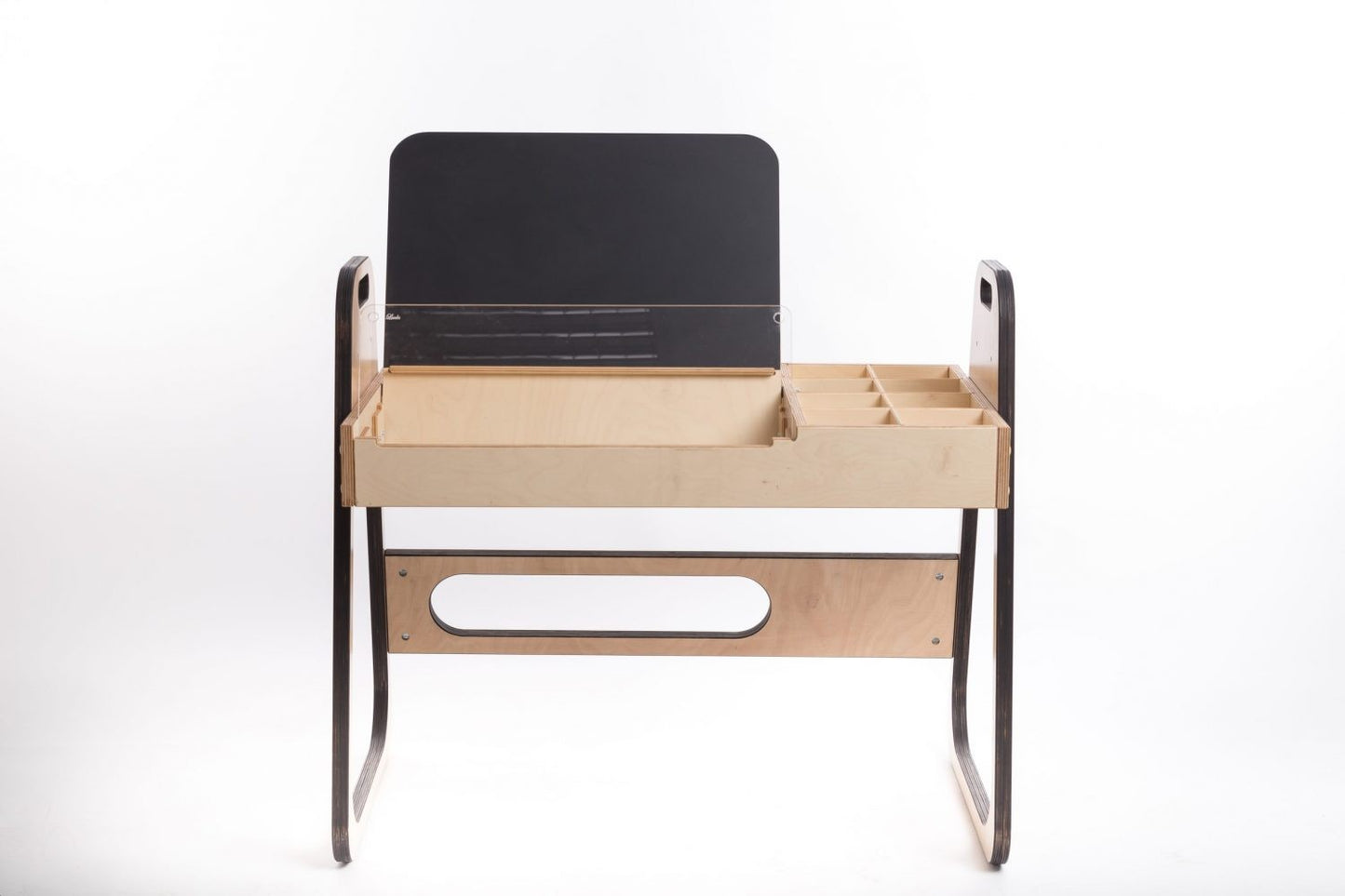 Flat-lay of Montessori table setup featuring open chalkboard and compartments for supplies