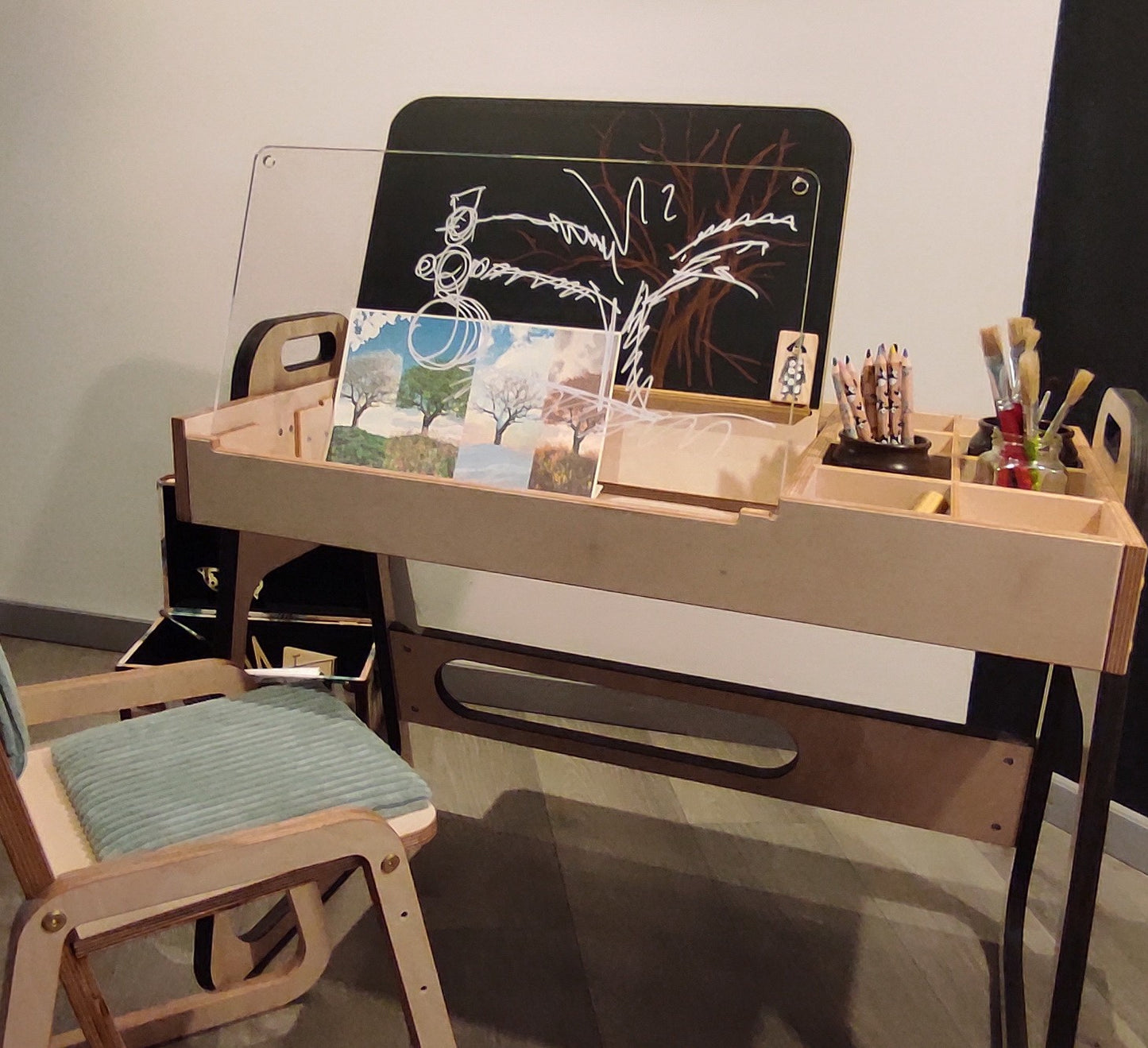 Hands holding Luula Julle chair by handle, showing portable and lightweight design
