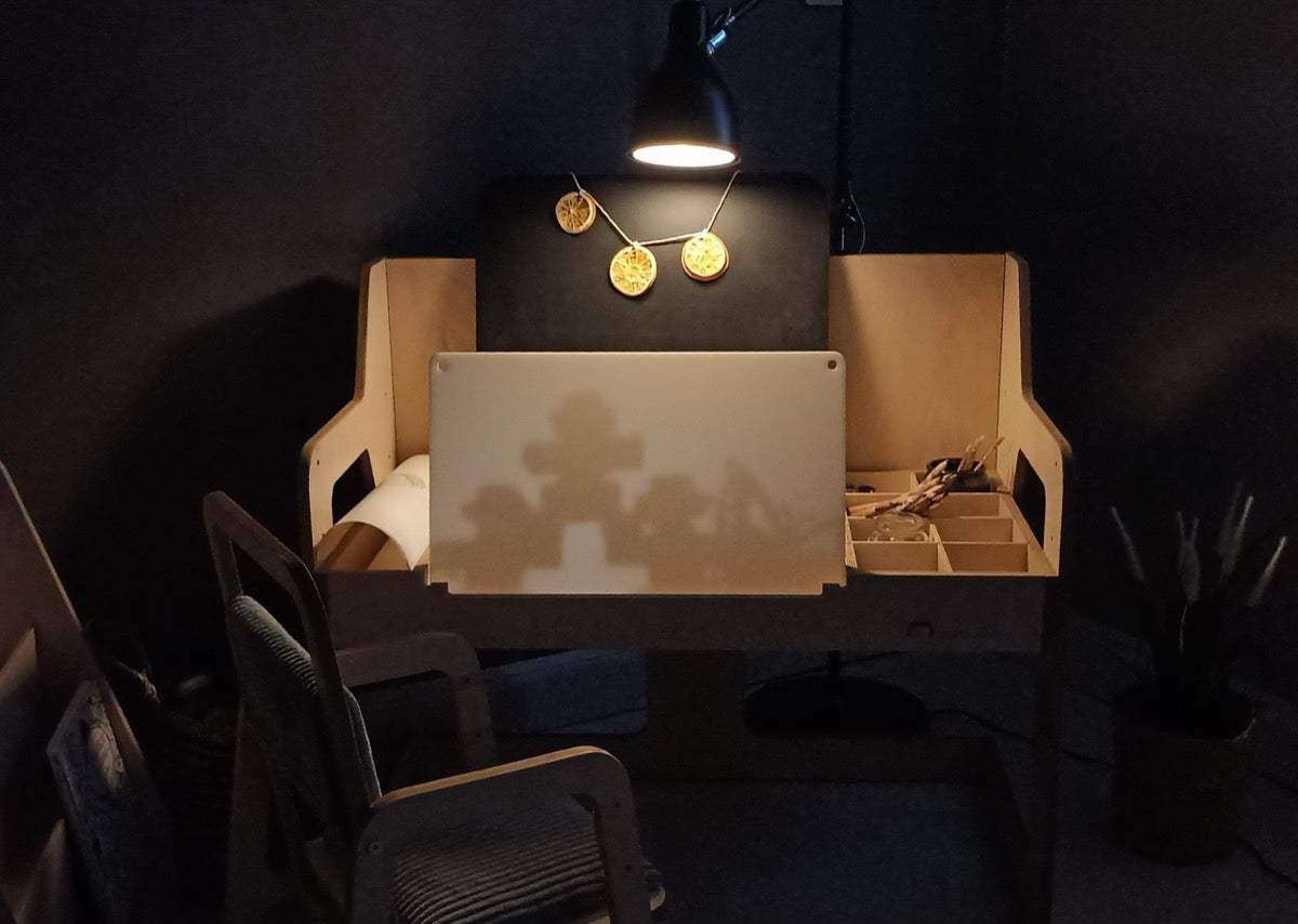 Top view of Montessori desk showing white work surface and organized compartments