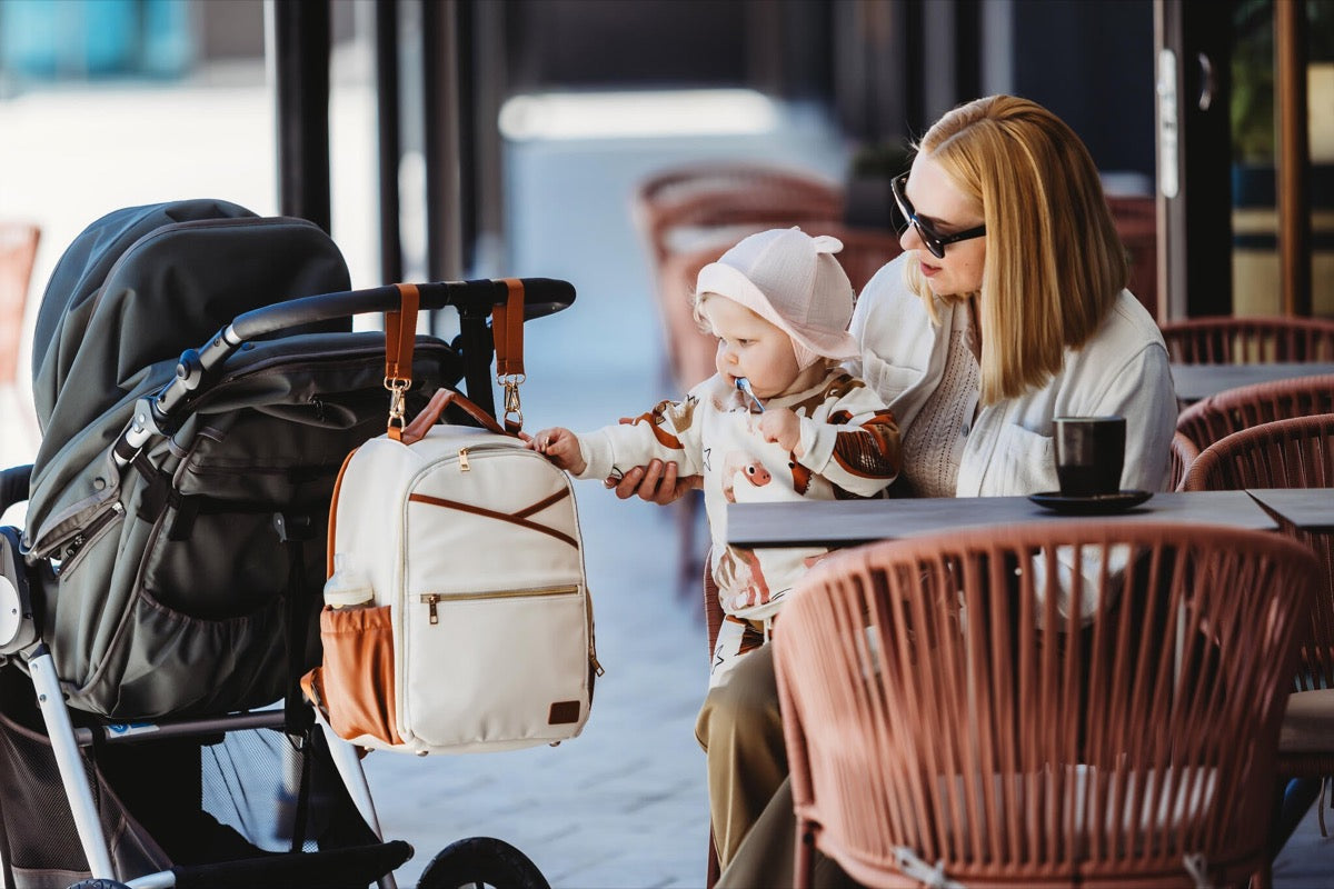 Ally Scandic Small Diaper Backpack Cappuccino – fold-out changing station on ground | Nestling