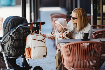 Ally Scandic Small Diaper Backpack Cappuccino – fold-out changing station on ground | Nestling