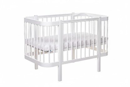 White KOTTO ELIN baby crib with closed side panel and slatted base, front angle view