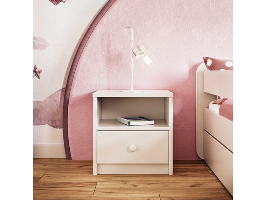 White Babydreams bedside table in pink kids' bedroom with open shelf and drawer