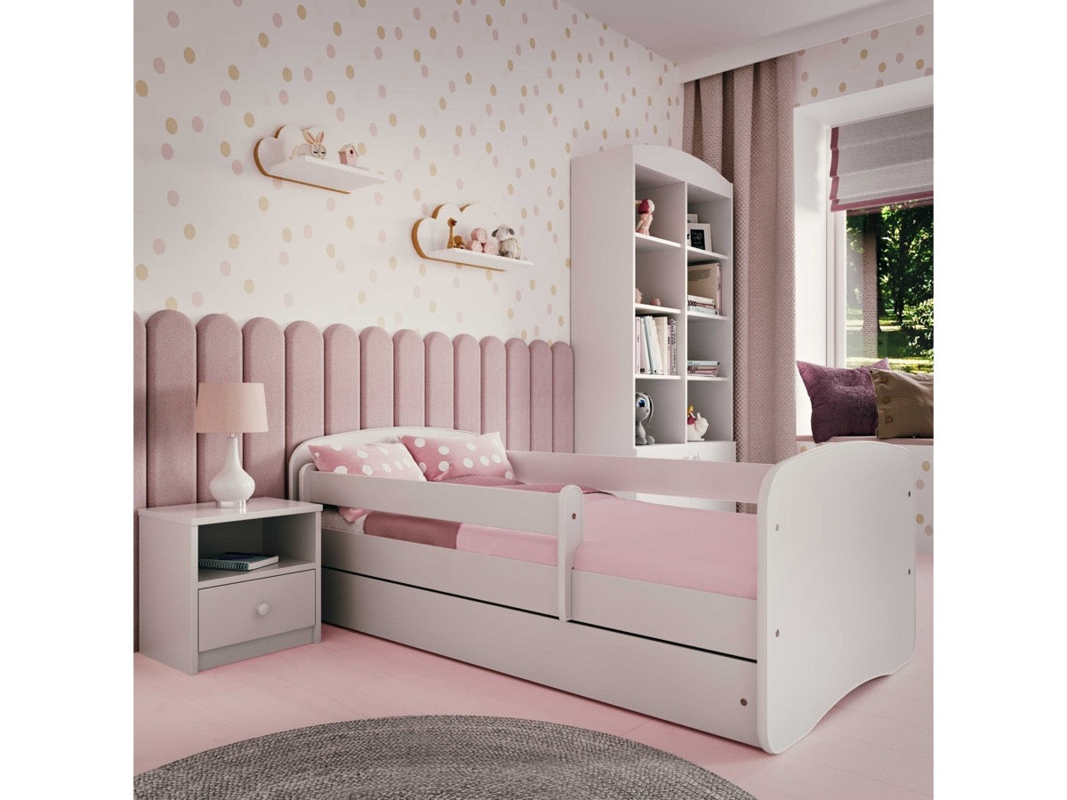 Pink children's bed with drawer in bedroom with coordinating furniture set