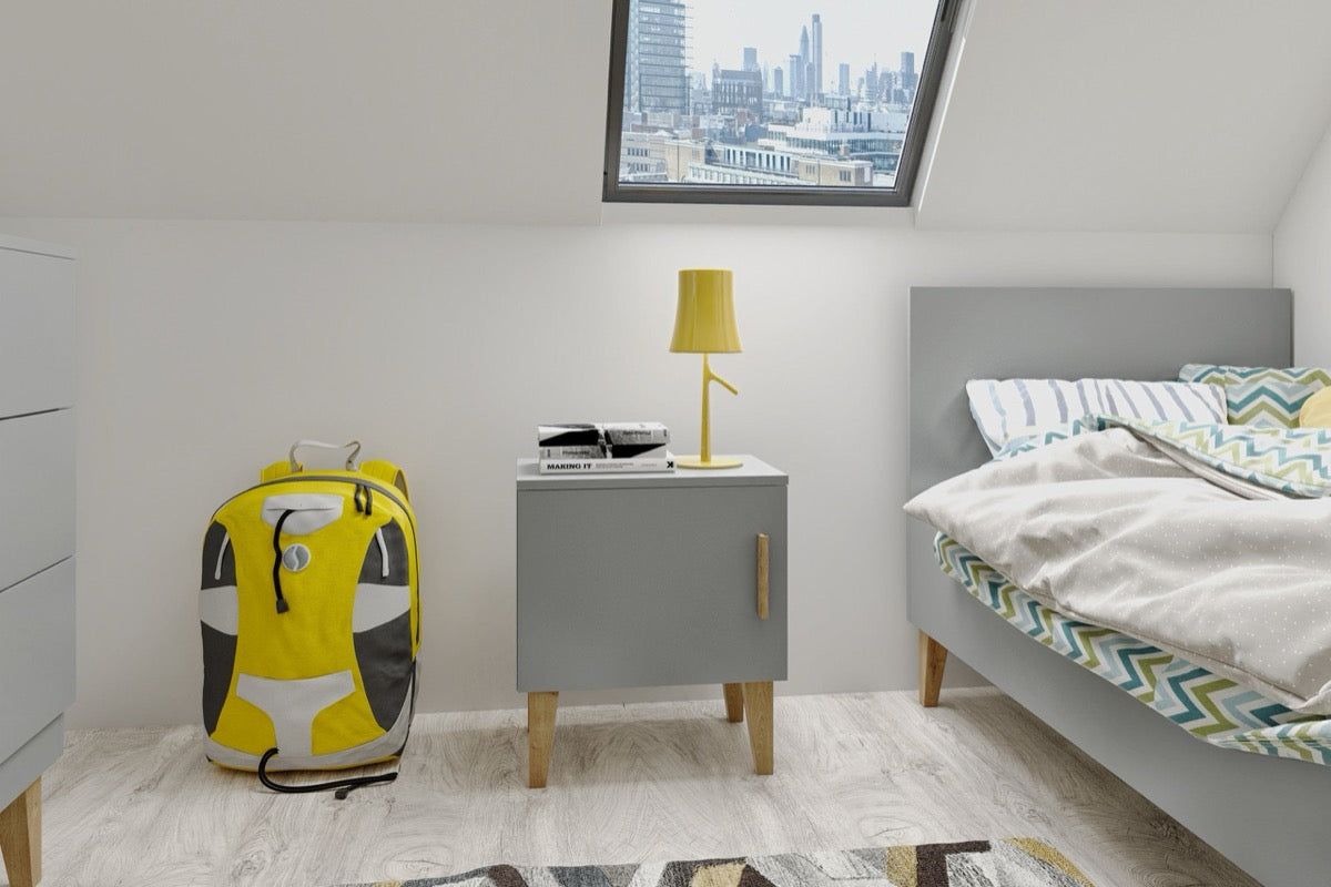 Grey Kubi bedside table with lamp and backpack, positioned next to child's bed