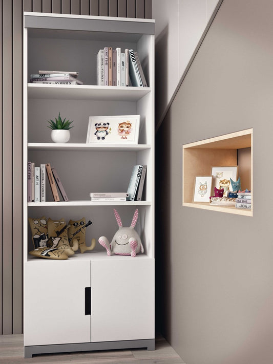 White Tomi kids bookshelf with four open shelves and lower storage cabinet, styled with books and toys