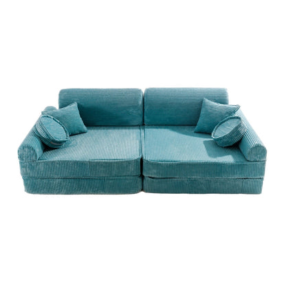 Turquoise corduroy modular sofa top view with two seats, throw pillows, and cylindrical cushions