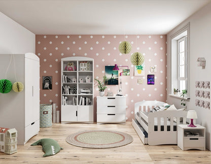 White classic chest of drawers styled in modern kids bedroom with pink polka dot wall