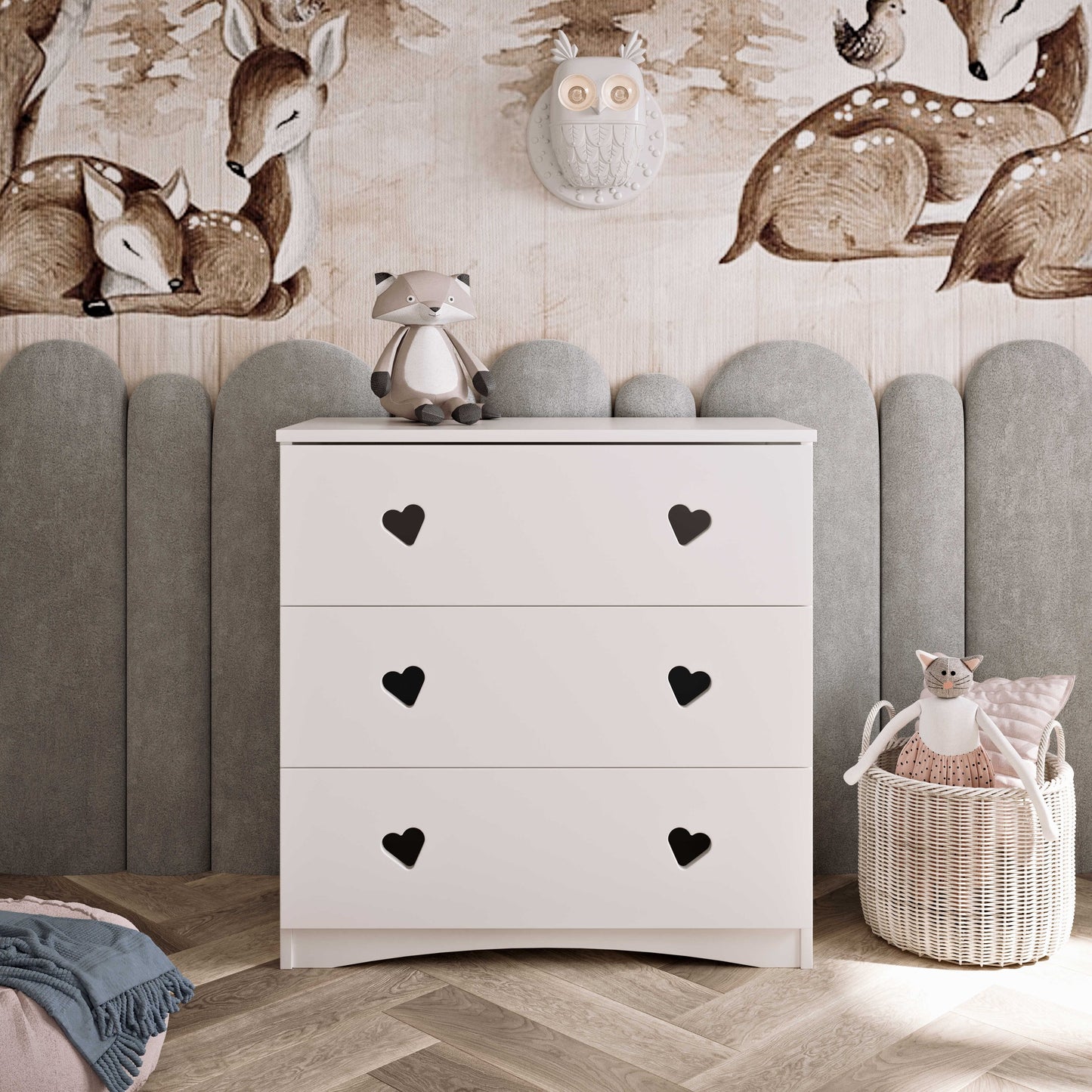 White three-drawer chest with heart cutout handles against upholstered headboard