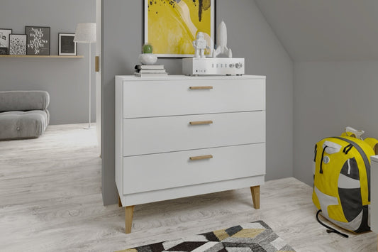 White Kubi chest of drawers in modern bedroom with oak legs and soft-close drawers