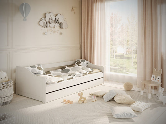 White Kocot Kids Blanka children's bed with pull-out drawer displayed in bright nursery room