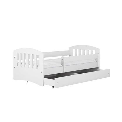 White kids bed with pull-out trundle drawer and protective guardrails, angled view