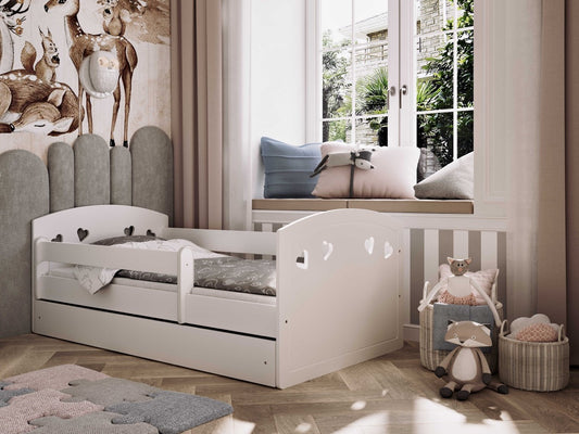 White Julia children's bed with heart cutouts in a bright nursery room setting