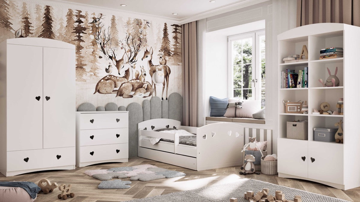 Woodland-themed nursery featuring white Julia bed with heart cutouts and matching storage