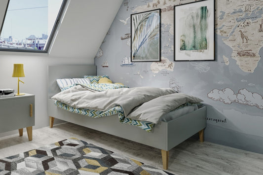 Grey Kubi children's bed with oak legs in Scandinavian bedroom setting with white bedding