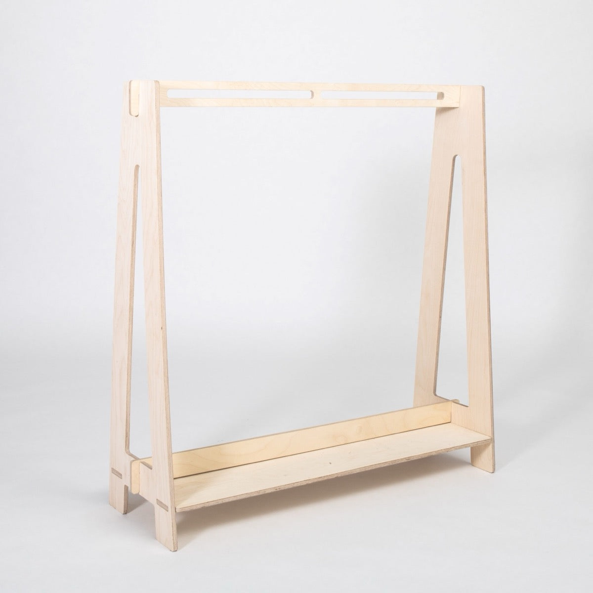 Natural birch plywood kids clothing rack with empty rail, front view against white background