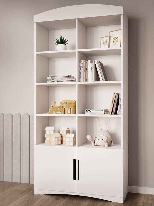 White double bookshelf styled with books, plants, and toys in a nursery room