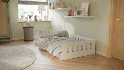 White Timon floor bed styled with bedding in bright nursery room setting