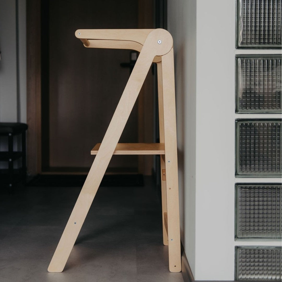 Natural wood kitchen tower unfolded showing A-frame structure with safety rail and single step platform