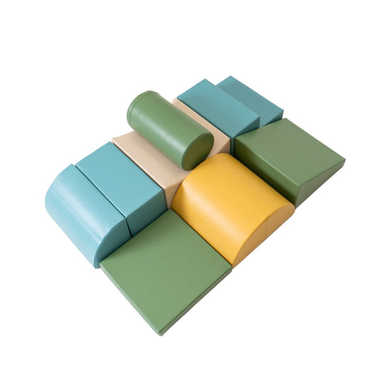 IGLU Soft Play foam block set arranged flat showing eight pastel turquoise, green, yellow and cream colored pieces