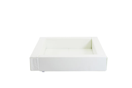 Empty white foam ball pit with low-profile entrance, angled front view