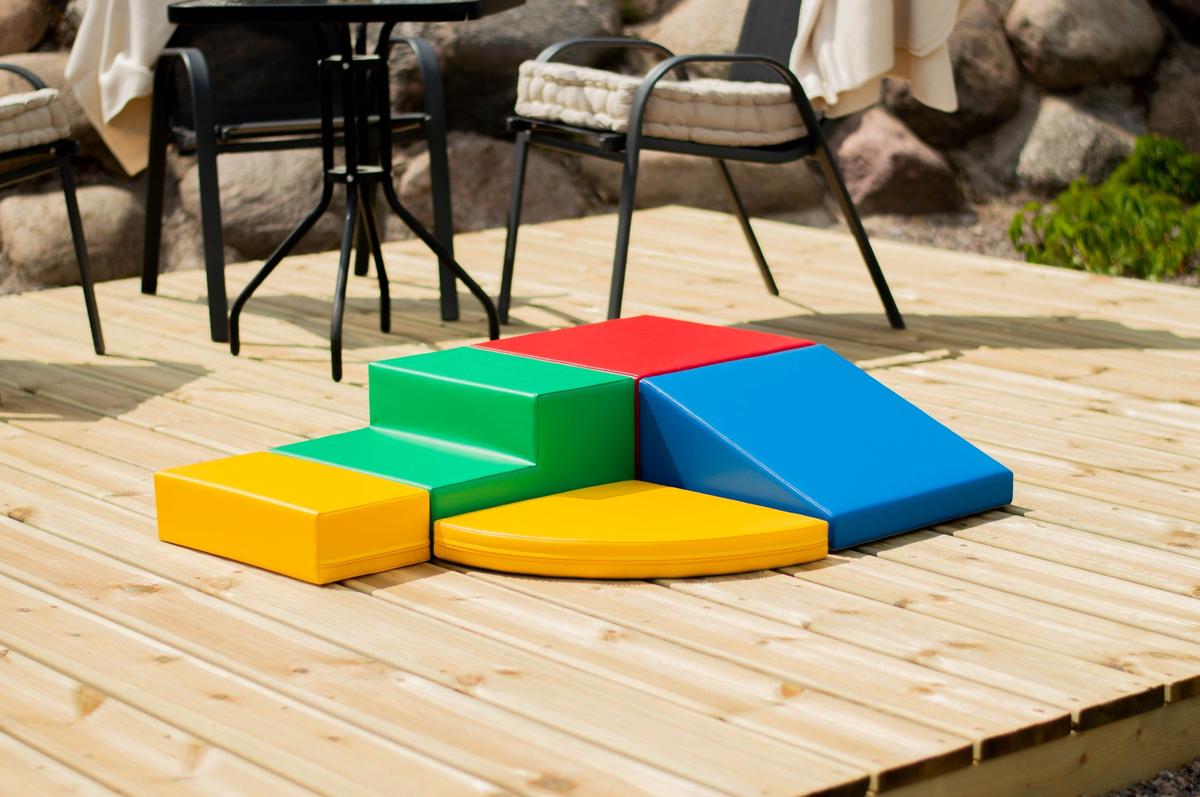 IGLU five-piece foam block set displayed on wooden patio with furniture nearby