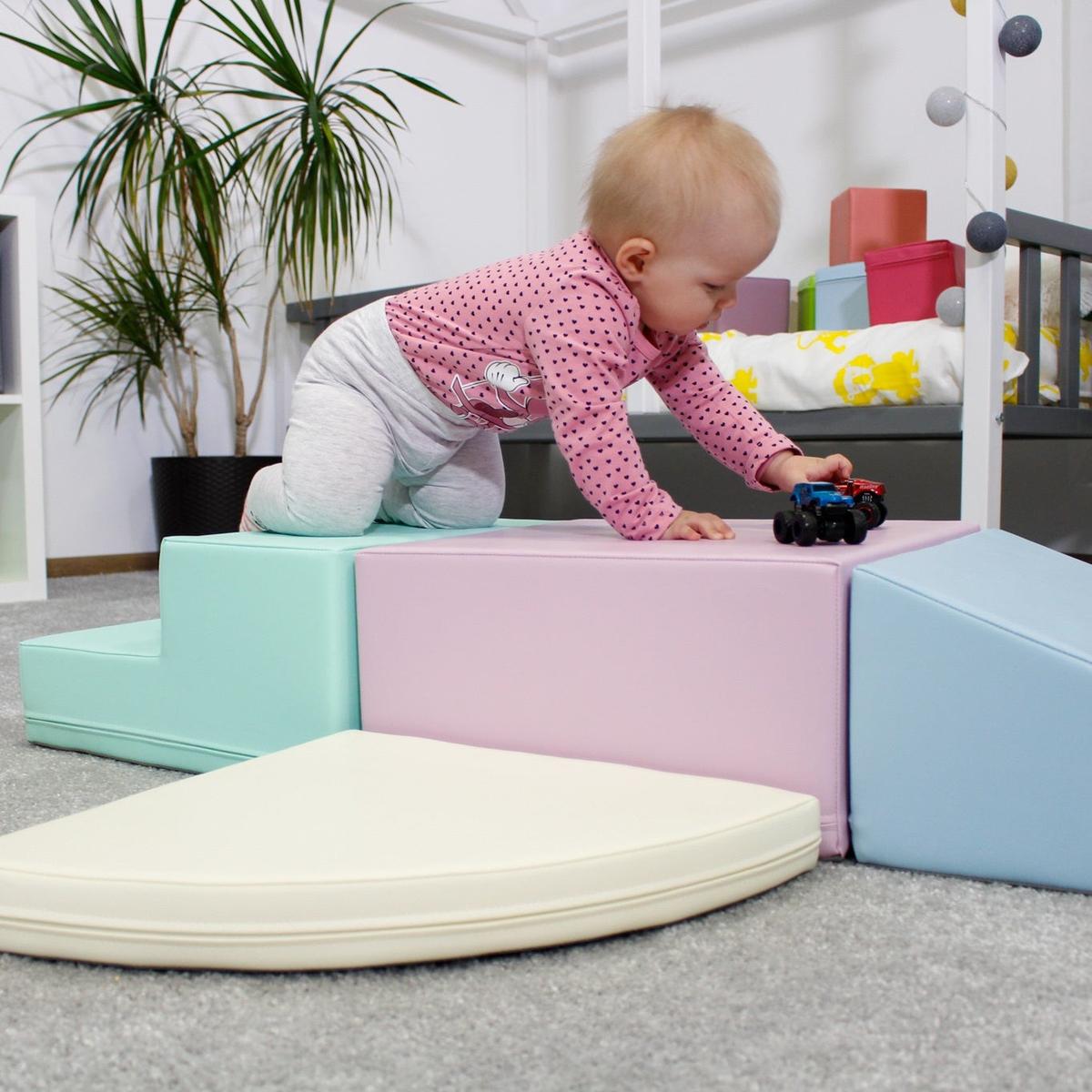 Baby exploring pastel foam blocks with stepping and climbing movements